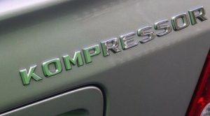 NEW GENUINE MERCEDES BENZ E CLASS REAR TRUNK KOMPRESSOR LETTERING CHROME BADGE A2038173015