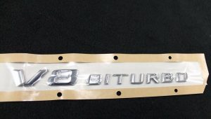 NEW GENUINE MERCEDES BENZ FRONT WING SILVER V8 BITURBO ADHESIVE BADGE A2228171615