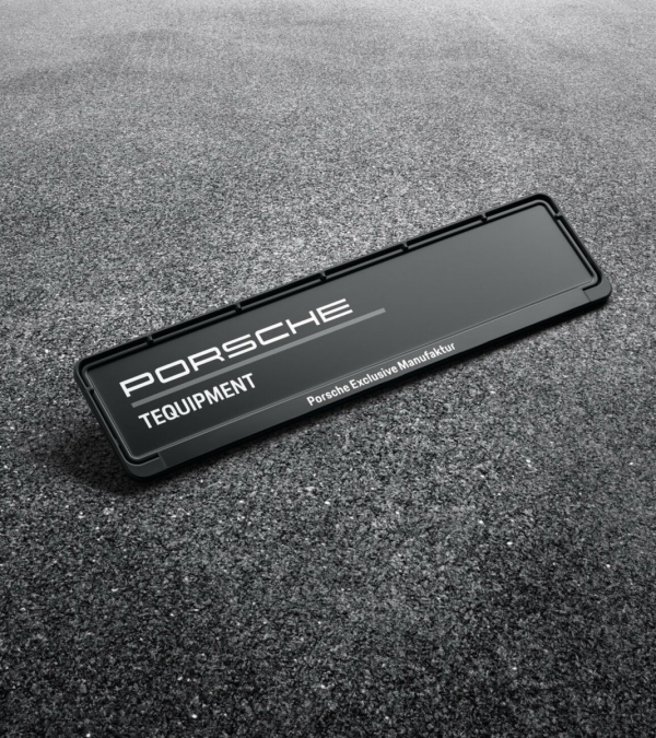 Black plastic genuine license plate frame with Porsche Exclusive Manufaktur logo